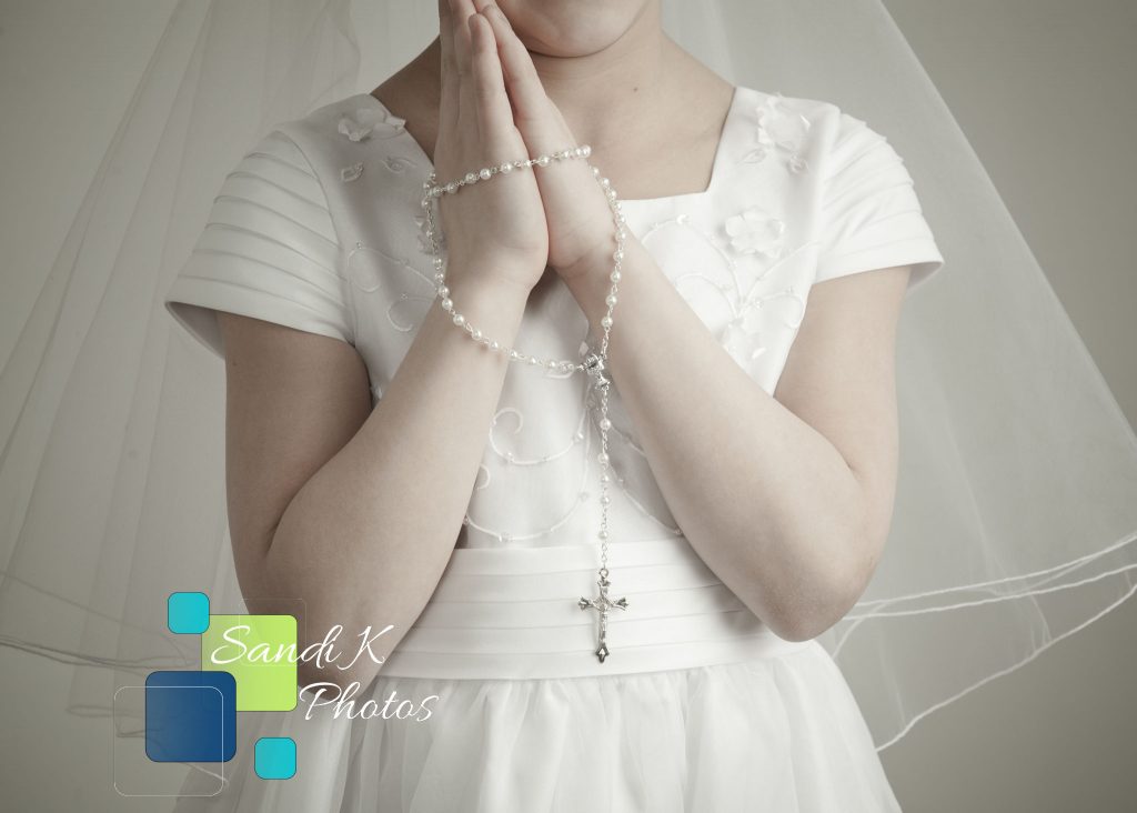 girl holding rosary in First Holy Communion photo